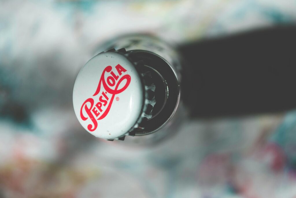 Showing a cap of a soda pop encasing its branding
